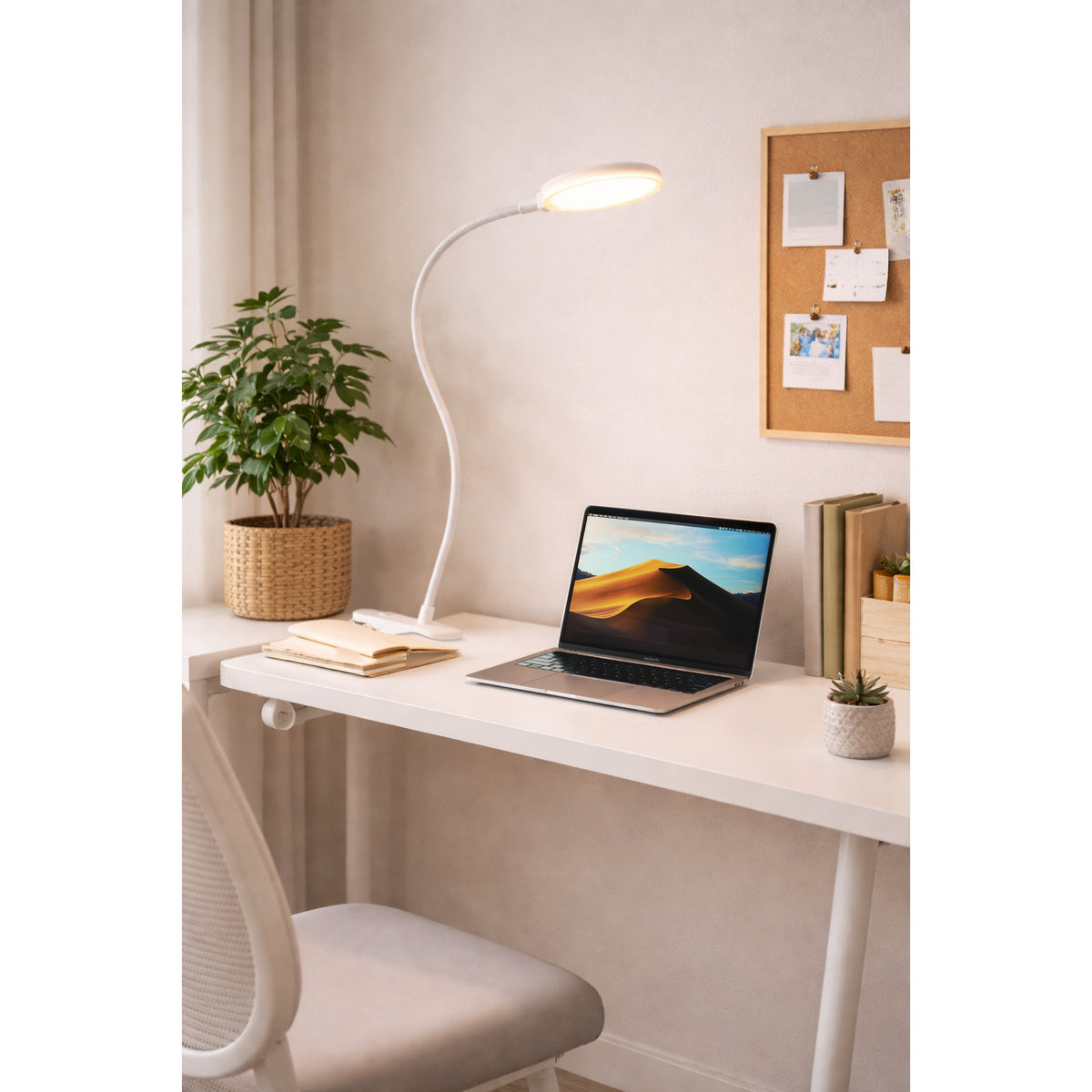 Casetto Clamp Lamp in white plastic with flexible gooseneck arm and round LED head, clamped to a desk beside a laptop in a study setting.