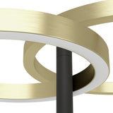 Close-up of the Castelpoto 1 LED floor lamp showing intersecting brushed brass rings with white diffuser edges around a slim black stem, set against a plain white background.