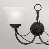 Mounted on a light gray wall, the Carisbrooke 2 Light Wall Light - Black features a black metal design and frosted glass lampshades. Its circular base and curved arms offer a classic and elegant look, reminiscent of Gothic-inspired lighting.