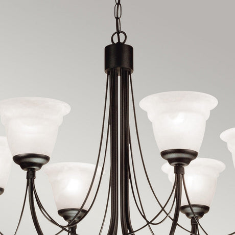 The Carisbrooke 6 Light Chandelier - Black showcases Gothic elegance with its metal arms and six white frosted glass shades, suspended from a chain against a light gray backdrop, creating a vintage ambiance.