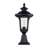 Introducing the Chicago Small Pedestal Lantern - Black: This stylish outdoor lantern boasts a vintage design, complete with a clear glass enclosure that elegantly houses a single light bulb. Featuring a decorative top and fluted base, it is perfect for illuminating your garden or adding charm to your porch.