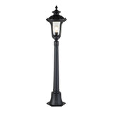 The Chicago Small Pillar Lantern - Black is a classic outdoor lamp post featuring a glass lantern that captures vintage aesthetics. Its exposed light bulb and intricate decorative elements make it an eye-catching addition to outdoor lighting, while its robust base guarantees durability.