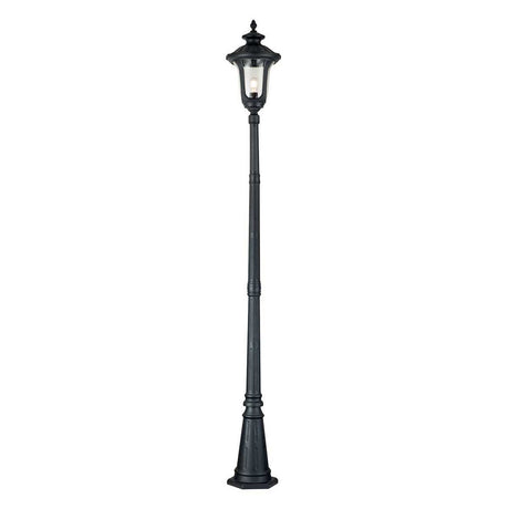 The Chicago Single Head Lamp Post - Black is a tall, vintage-style street lamp featuring a classic lantern design with a single bulb, standing on a wide base. Made from durable aluminium construction, this elegant outdoor fixture beautifully illuminates against the plain white background.