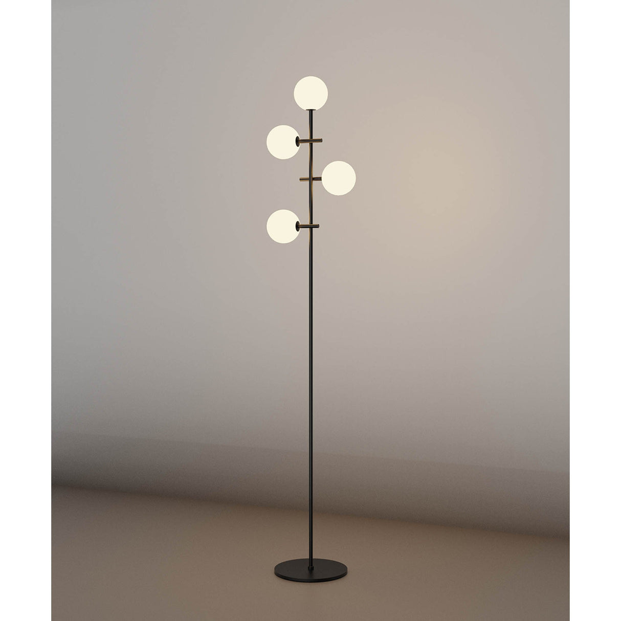The Cellar LED Floor Lamp 5W 4000K - Black features four white glass globes at different heights on a sleek black stand, providing soft ambient lighting that enhances any plain wall.
