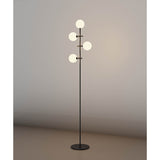 The Cellar LED Floor Lamp 5W 4000K - Black features four white glass globes at different heights on a sleek black stand, providing soft ambient lighting that enhances any plain wall.