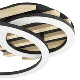 Close-up of the Cembrano LED flush ceiling light, 41cm, showing overlapping white-shaded rings over a black base with natural wood slats, finished in black, natural wood and steel.