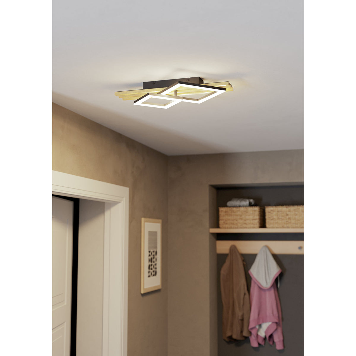 Cembrano LED flush ceiling light in black and natural wood with offset square frames, installed in a hallway above a coat rack with baskets and hanging garments.