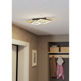 Cembrano LED flush ceiling light in black and natural wood with offset square frames, installed in a hallway above a coat rack with baskets and hanging garments.