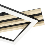Close-up of the Cembrano LED flush ceiling light, black steel base with natural wood slats and black felt strips, overlaid by offset square frames in black with white plastic diffusers.