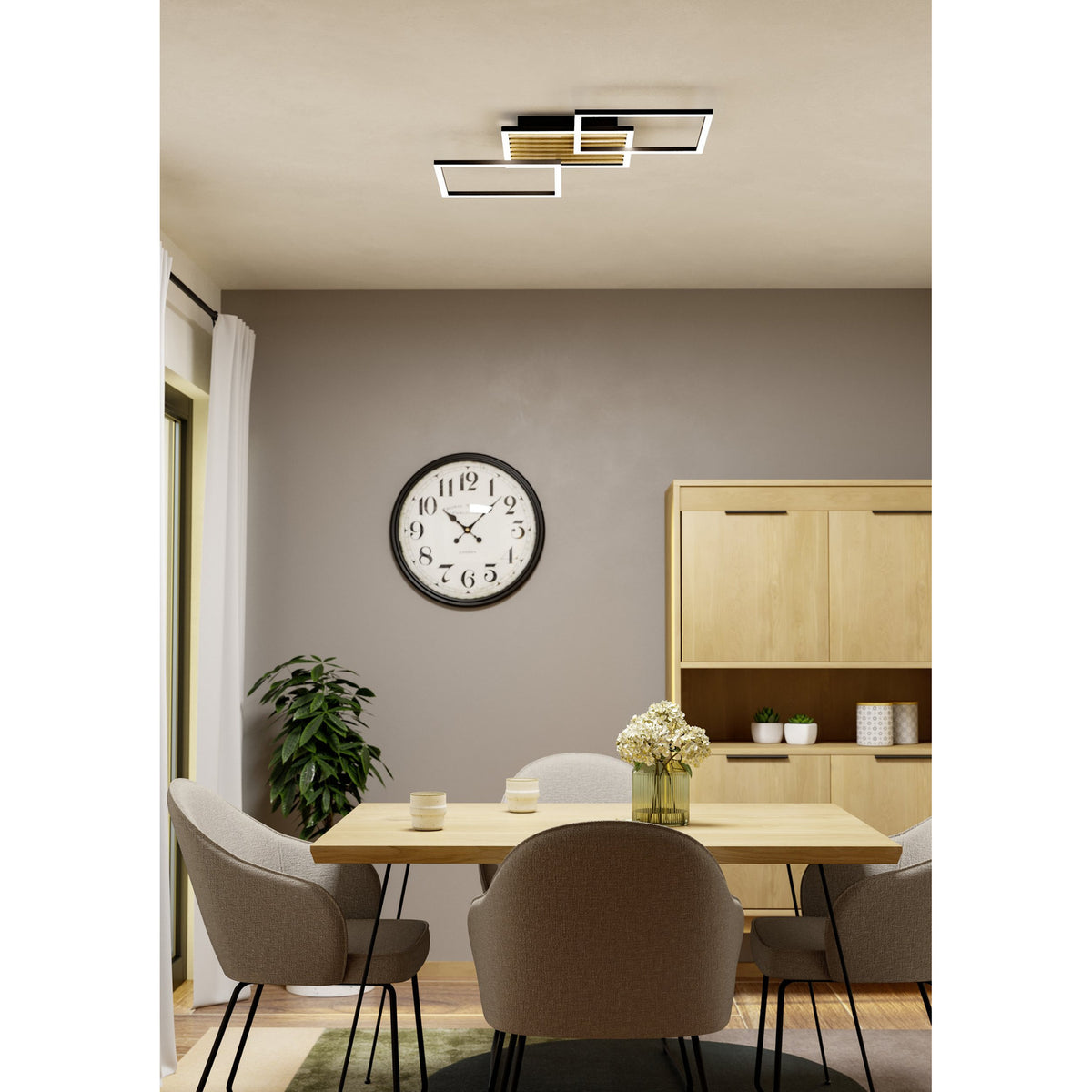 Cembrano LED Flush Ceiling Light 92.5cm in black and natural wood, overlapping square frame design, shown on the ceiling of a dining room with a wall clock and wooden sideboard below.