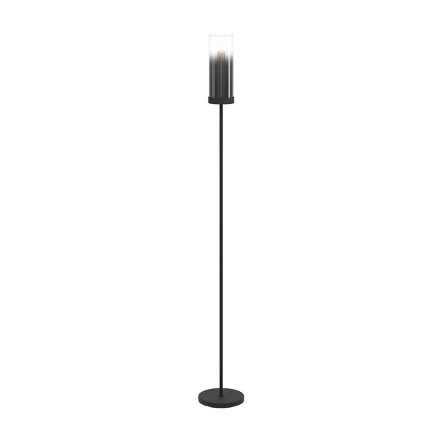 Cesarne Floor Lamp in black steel with a slim column and round base, topped by a cylindrical smoked glass shade fading to clear, single E27 fitting, on a plain white background.