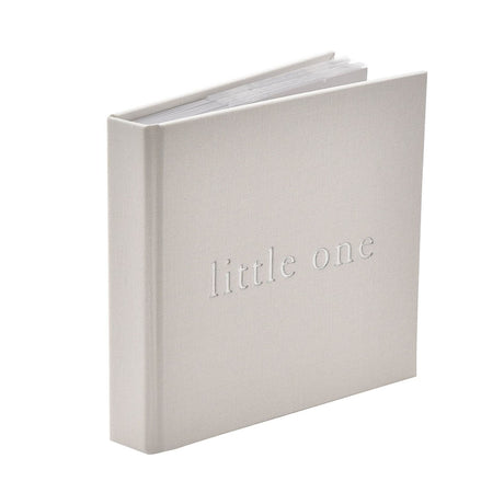 Little One square linen baby photo album in white with embossed "little one" lettering on the cover, shown upright against a plain white background.