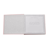 Open pink photo album showing a star-patterned inner cover and a ruled page titled "hello little one" with printed verse, for 6 x 4in prints.