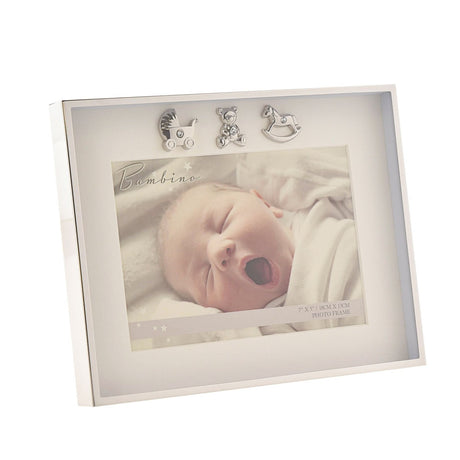 Silverplated rectangular photo frame with thin polished border, white mount, and three silver charms—pram, teddy bear, and rocking horse—holding a 7 x 5in baby photo.