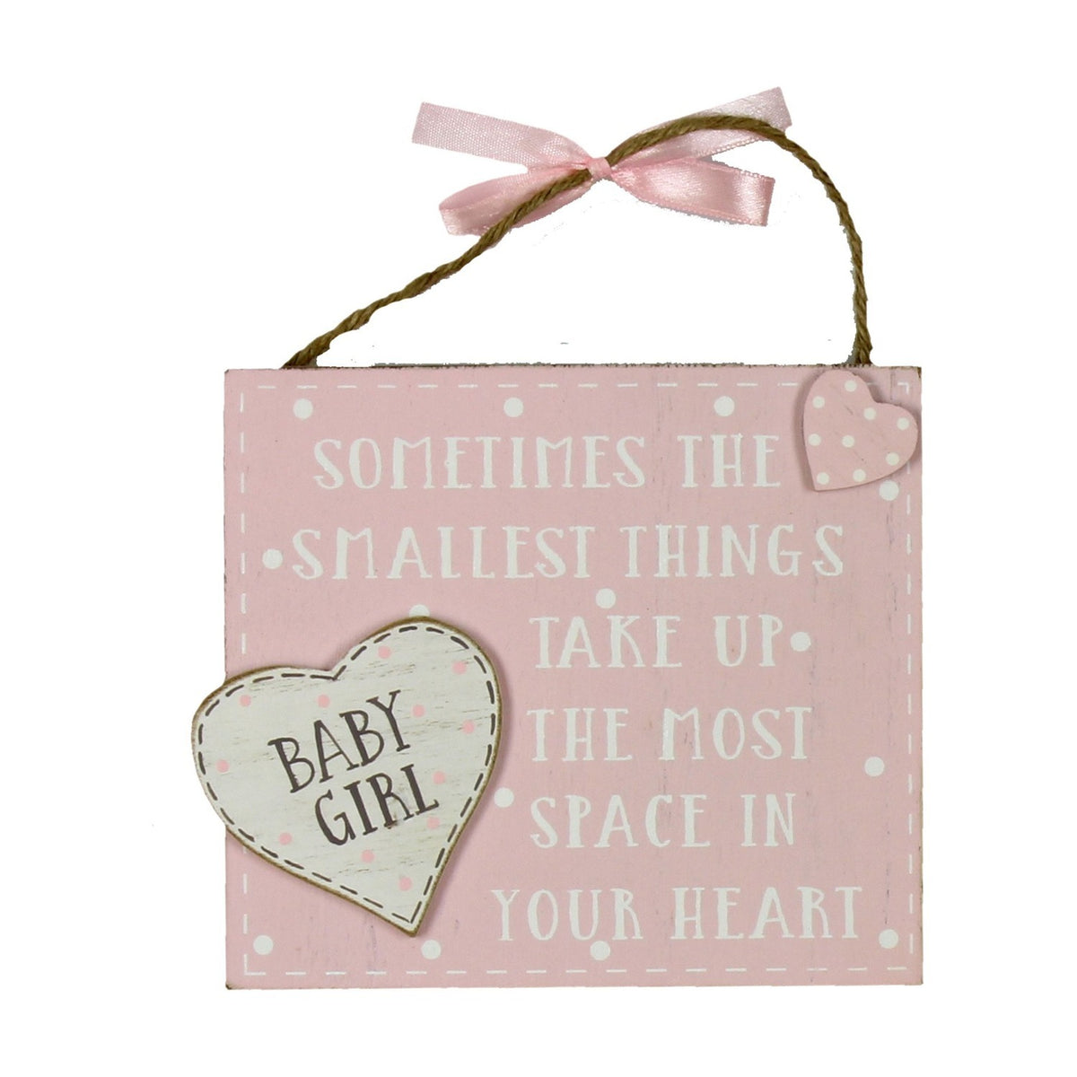 Pink MDF hanging plaque reading Sometimes the smallest things take up the most space in your heart, with a cream Baby Girl heart and pink spotted heart accent, hung by a pink ribbon on twine.