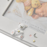 White resin 4x4in photo frame corner detail with a teddy bear holding a gold heart, pink and grey stars, a crescent moon, and "10cm x 10cm Photo Frame" text.