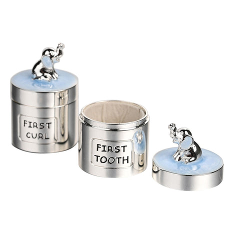 Silverplated round keepsake box set in blue, labelled "First Curl" and "First Tooth" with elephant figures on the lids, one shown open with a soft lining, on a white background.