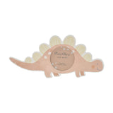 Stegosaurus-shaped MDF photo frame in soft pink with white spots and pale yellow back plates, featuring a round 3.5 x 3.5in photo window, shown on a plain white background.