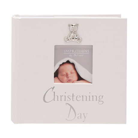 White pearlised square photo album with silver teddy bear and "Christening Day" lettering, featuring a square photo window holding a 6 x 4in baby picture.