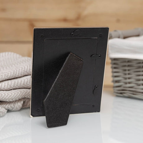 Rear view of the Teddy Bear Silverplated Photo Frame, 5 x 3.5in portrait, showing black easel stand and hanging hooks, set against a neutral lifestyle background.