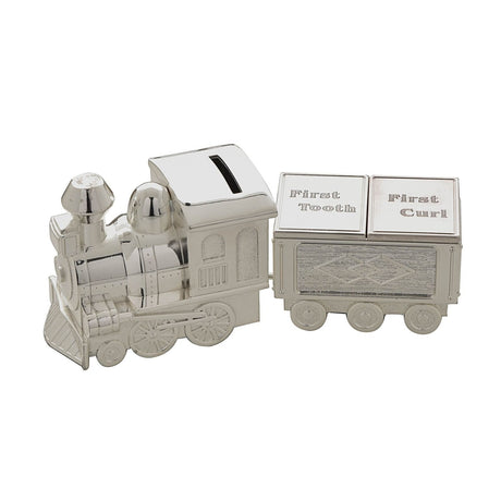Silverplated metal train money box with coin slot in the engine roof and a carriage featuring hinged "First Tooth" and "First Curl" lids, on a plain white background.