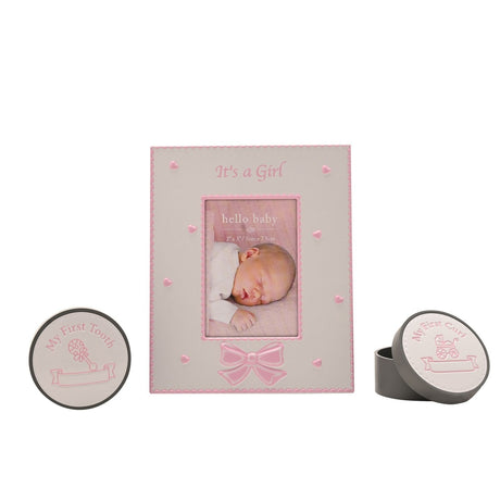 Pink "It's a Girl" 3x2in photo frame with heart and bow details, alongside round aluminium "My First Tooth" and "My First Curl" keepsake boxes on a white background.