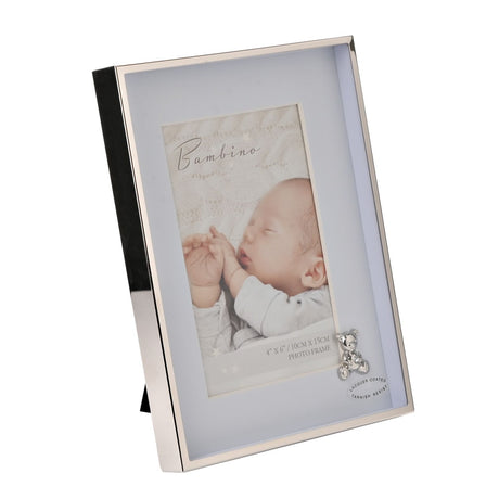Rectangular photo frame with silver metal border and pale blue mount for a 6x4in photo, featuring a small silver teddy bear and sparkling stone accent at the corner.