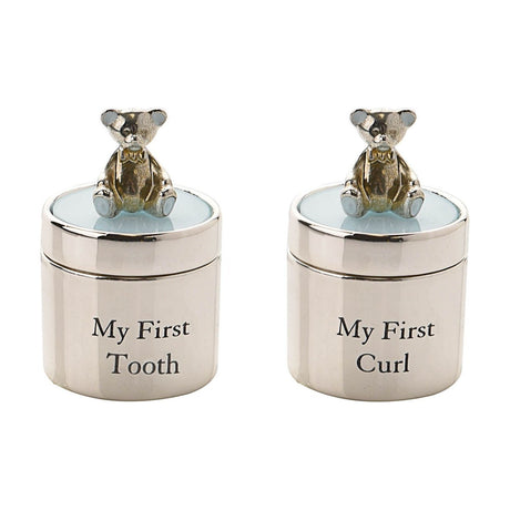 Round silverplated keepsake box set with teddy bear lid toppers and pale blue lids, reading "My First Tooth" and "My First Curl" on a plain white background.