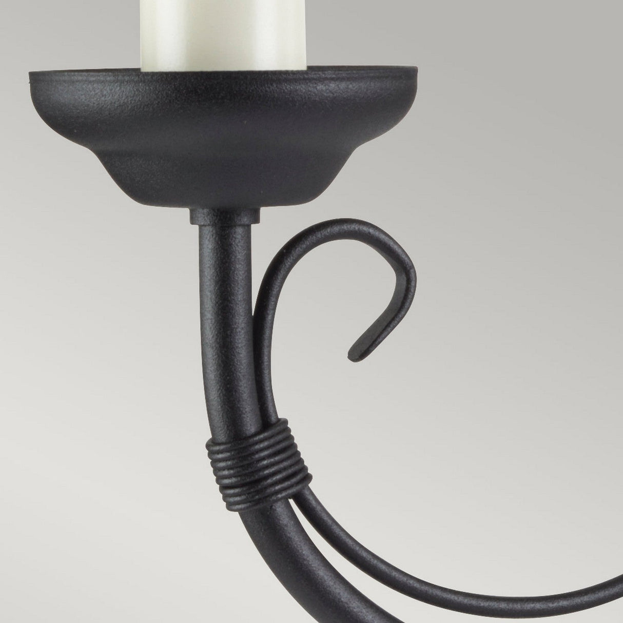 Close-up of the Chartwell 2 Light Wall Light in black, radiating traditional charm with its elegantly curved design. The fixture is complemented by cream-colored cylindrical elements, all set against a soft gradient of gray tones.