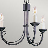 The Chartwell 3 Light Chandelier in black is ideal for adding a vintage touch to your home décor, showcasing three candle-shaped light bulbs on elegantly curved arms against a simple light grey background.