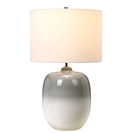 The Chalk Farm Table Lamp features a smooth, rounded ceramic base with a gradient transitioning from chalk white to light grey. It includes a large faux silk cylindrical shade and is finished with a polished nickel finial, providing a soft and warm glow.