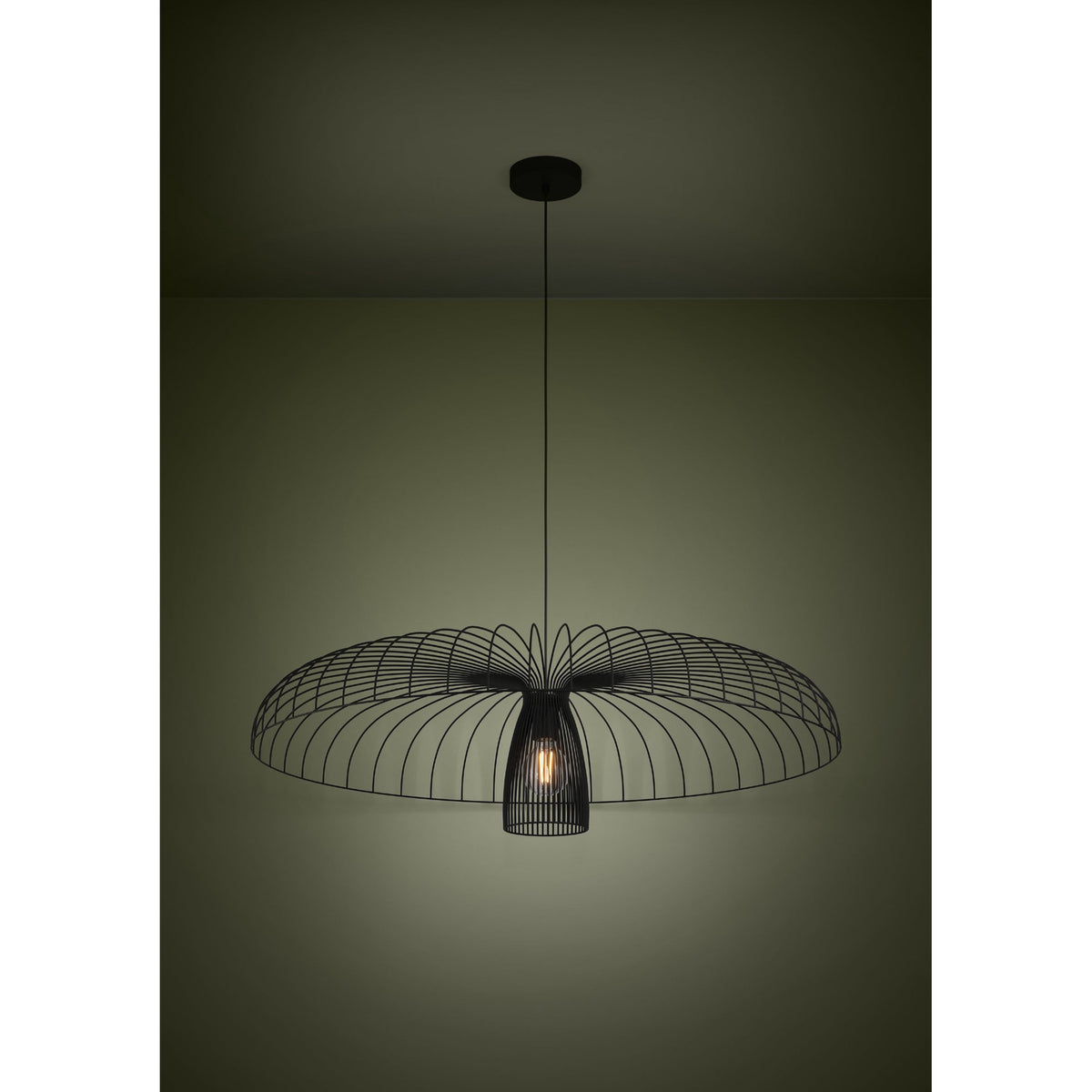 Champerico Pendant Light 98.5cm in black steel, wide open wire-cage canopy over a slatted inner shade with a single E27 bulb, hung from a black ceiling rose in a dimly lit room.