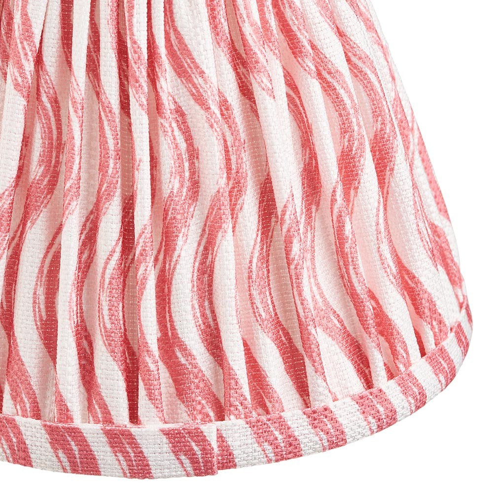 Close-up of Endon Chartwood 16cm tapered lamp shade in coral pink, showing pleated faux linen with a rippled print and taped edge trim.