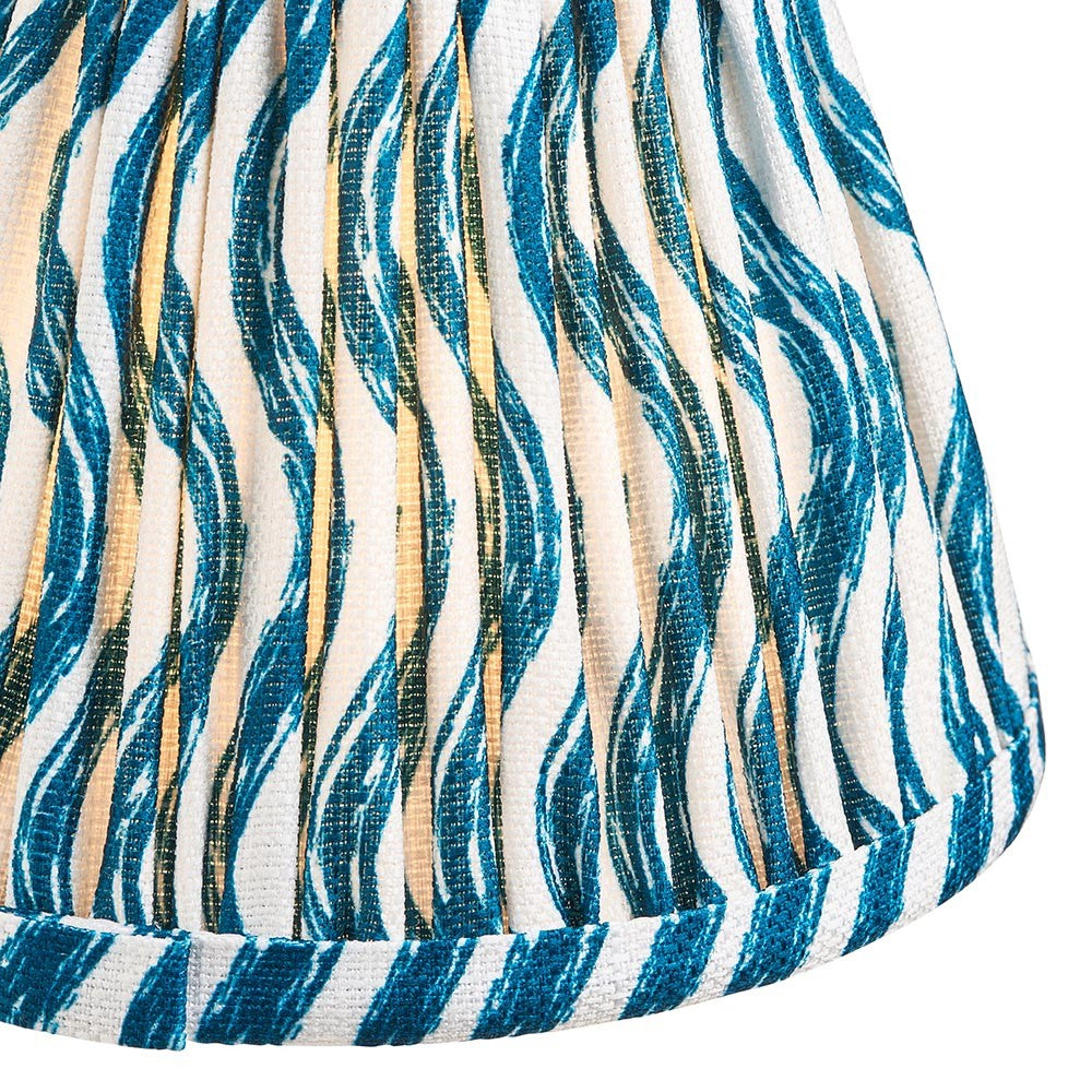 Close-up of the Endon Chartwood 16cm tapered lamp shade in marlin blue, showing pleated faux linen with a rippled blue and cream print and taped edge.