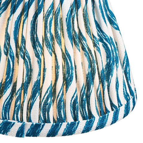 Close-up of the Endon Chartwood 16cm tapered lamp shade in marlin blue, showing pleated faux linen with a rippled blue and cream print and taped edge.
