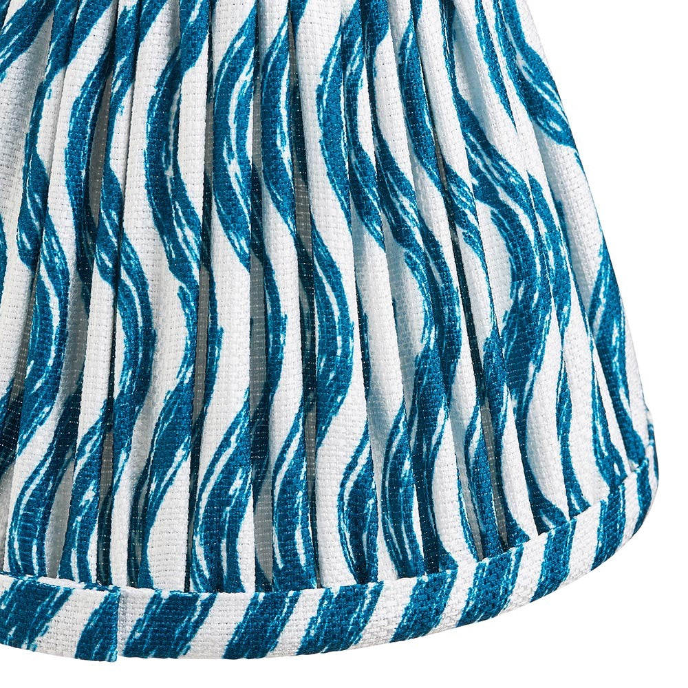 Close-up of Endon Chartwood 16cm tapered lamp shade in marlin blue, showing pleated faux linen with a rippled blue and white print and taped edge.