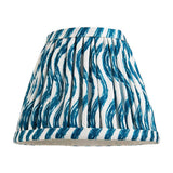 Endon Chartwood 16cm tapered lamp shade in Marlin Blue, pleated faux linen with a rippled blue and white print and taped edges, on a white background.