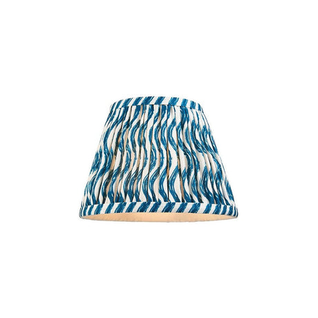 Endon Chartwood 20cm tapered lamp shade in marlin blue, pleated faux linen with a rippled blue and white print and taped edges, on a white background.