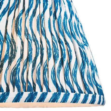 Close-up of Endon Chartwood 20cm tapered lamp shade in marlin blue and white, showing pleated faux linen with a rippled print and taped edge trim.