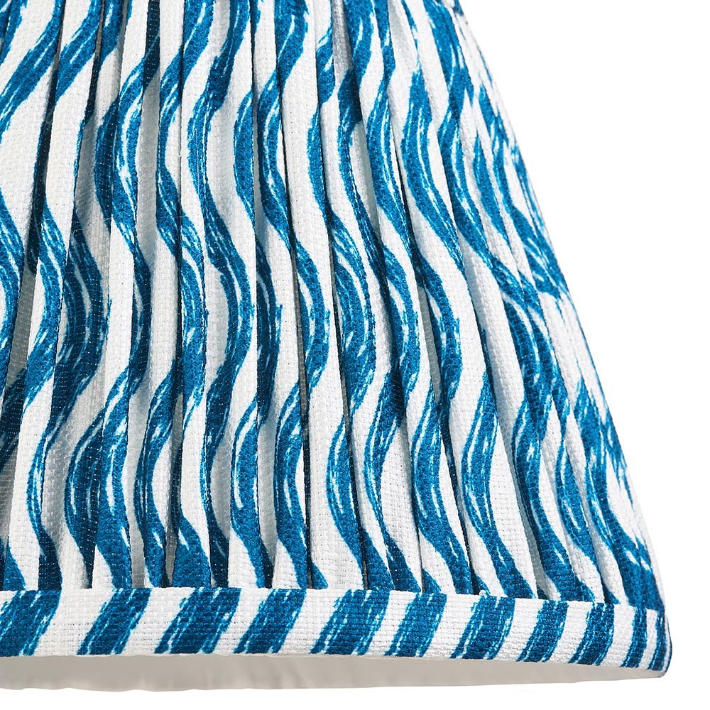 Close-up of the Endon Chartwood 20cm tapered lamp shade in marlin blue, showing pleated faux linen with a rippled blue and white print and taped edge.