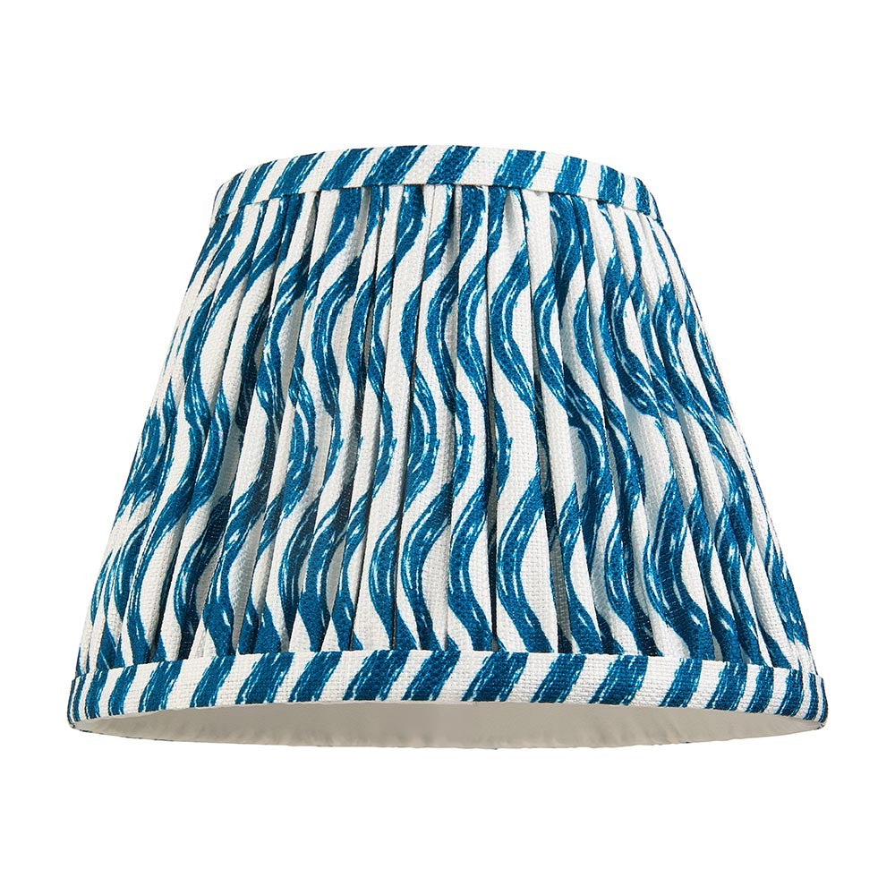 Endon Chartwood 20cm tapered lamp shade in marlin blue and white pleated faux linen with a rippled wave print and taped edge trim, on a white background.
