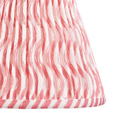 Close-up of the Chartwood 25cm tapered lamp shade in coral pink, showing pleated faux linen fabric with a ripple pattern and taped edge trim.