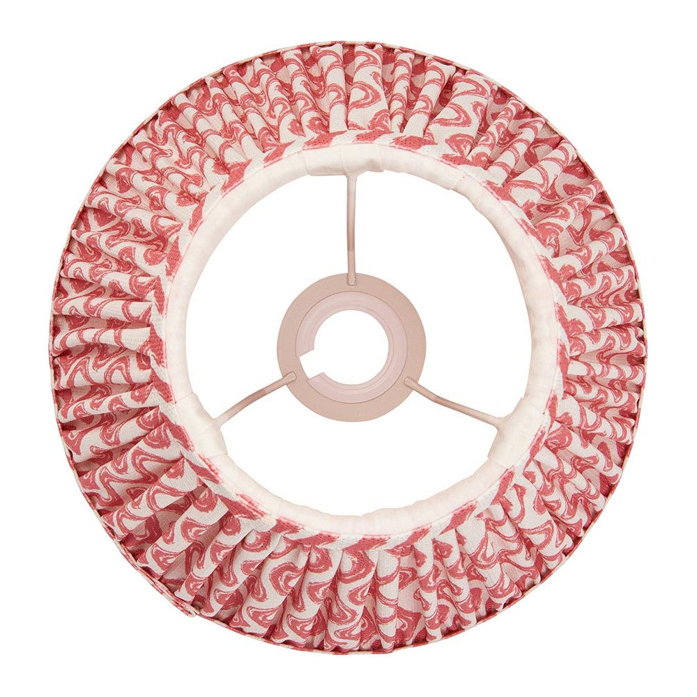 Chartwood 25cm tapered lamp shade in coral pink faux linen with pleated ripple pattern and white taped edges, shown from above on a plain white background.