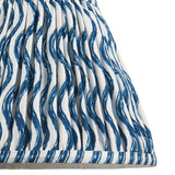 Close-up of Endon Chartwood 25cm tapered lamp shade in marlin blue, showing pleated faux linen with a rippled wave print and taped edge detail.