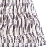 Close-up of the Endon Chartwood 25cm tapered lamp shade in pearl grey, showing pleated faux linen with a soft grey ripple print and taped edge trim.