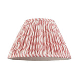 Endon Chartwood 30cm tapered lamp shade in coral pink and white pleated faux linen with a rippled print and taped edge, shown on a plain background.