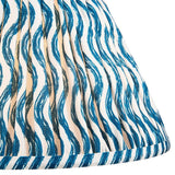 Close-up of the Endon Chartwood 30cm tapered lamp shade in Marlin Blue, showing pleated faux linen with a rippled blue and white print and taped edge.