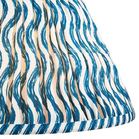 Close-up of the Endon Chartwood 30cm tapered lamp shade in Marlin Blue, showing pleated faux linen with a rippled blue and white print and taped edge.