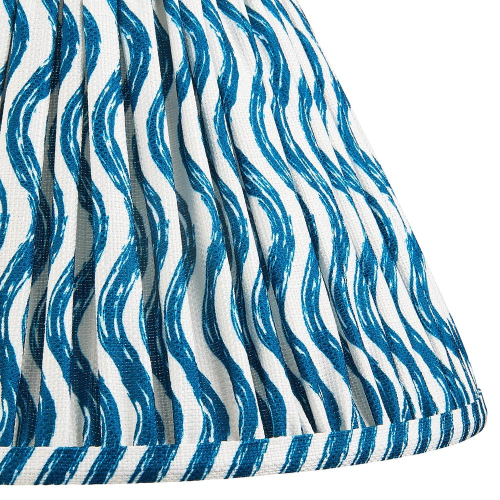Close-up of Endon Chartwood 30cm tapered lamp shade in marlin blue, showing pleated faux linen with a blue ripple print and taped edge trim.