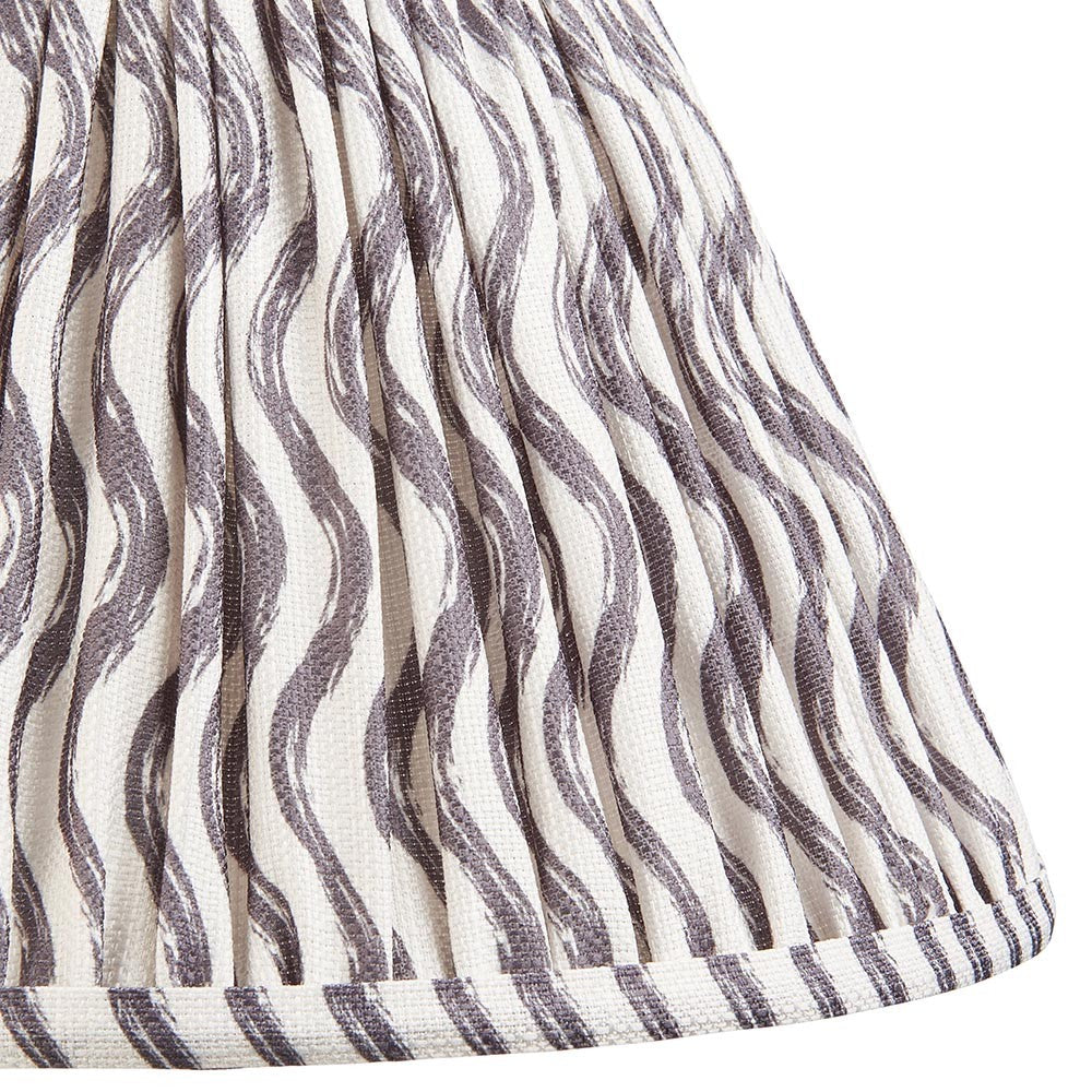 Close-up of Endon Chartwood 30cm tapered lamp shade in pearl grey, showing pleated faux linen with a rippled grey wave print and taped hem.